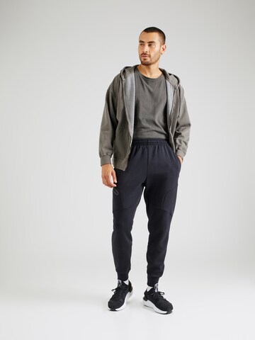 Effilé Pantalon de sport 'Unstoppable' UNDER ARMOUR en noir