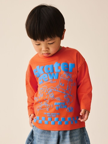 Next Shirt in Orange: Vorderseite