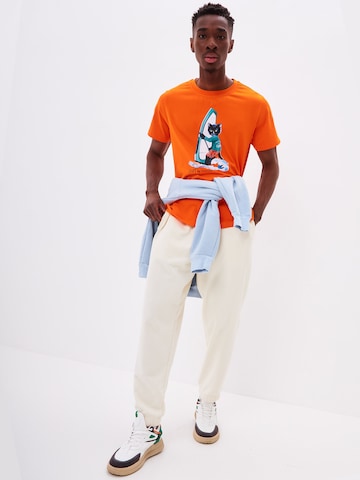 T-Shirt 'SURFER CAT' CAT by Maniita Lacitta en orange