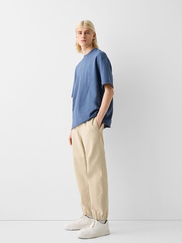 Bershka Дънки Tapered Leg Дънки в бежово