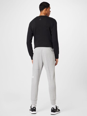 ADIDAS SPORTSWEAR Tapered Urheiluhousut 'Essentials' värissä harmaa