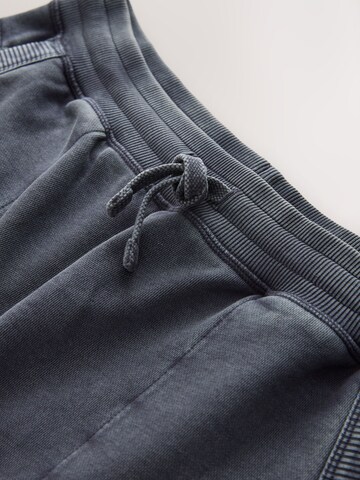 pilka Next Plačios klešnės Kelnės