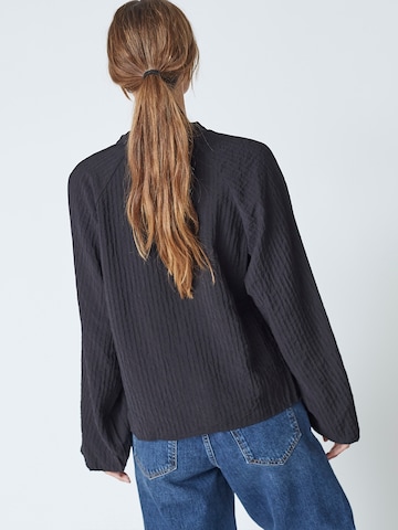 Chemisier 'Shina' co'couture en noir