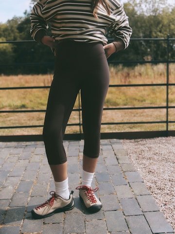 self. Skinny Workout Pants in Brown: front