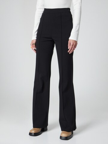 florence by mills exclusive for ABOUT YOU Flared Trousers 'Spruce' in Black: front