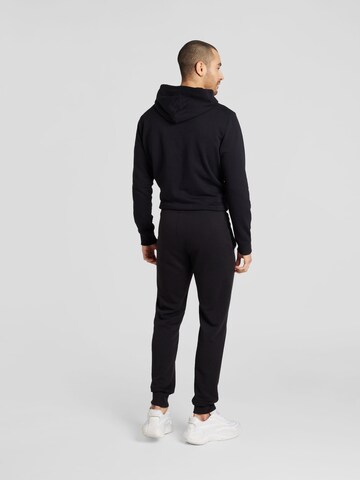 Champion Authentic Athletic Apparel Tapered Trousers 'Legacy' in Black