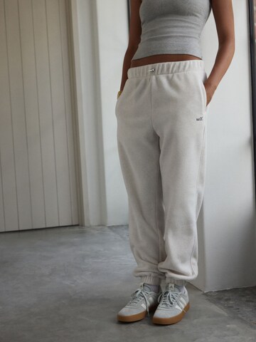 self. Tapered Pants in Beige: front