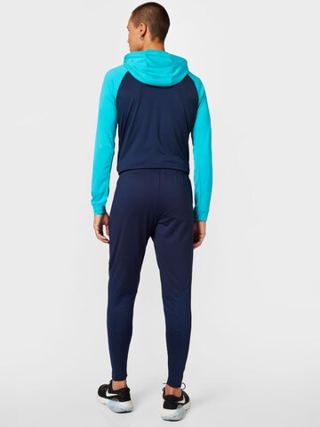 NIKE Tapered Workout Pants in Blue
