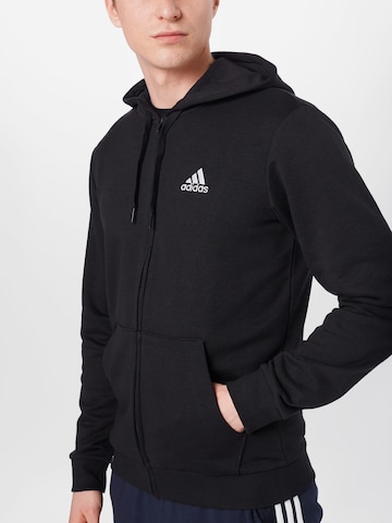 ADIDAS SPORTSWEAR Спортна жилетка с качулка в черно