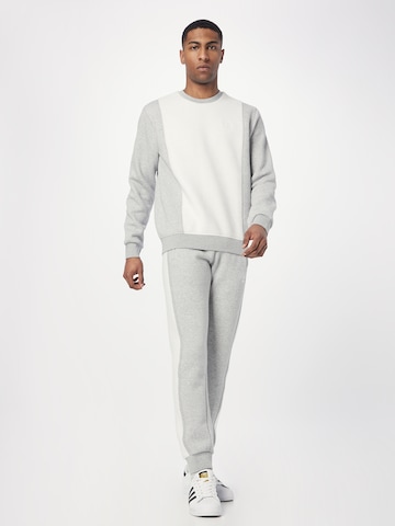 ADIDAS ORIGINALS Tapered Pants 'Trefoil Essentials+ Reverse Material' in Grey