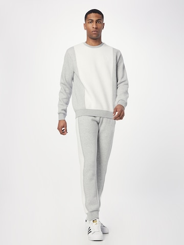 ADIDAS ORIGINALS Tapered Trousers 'Trefoil Essentials+ Reverse Material' in Grey