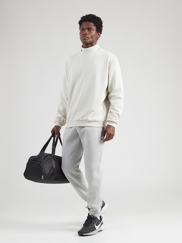 UNDER ARMOUR Tapered Urheiluhousut 'Essential' värissä harmaa