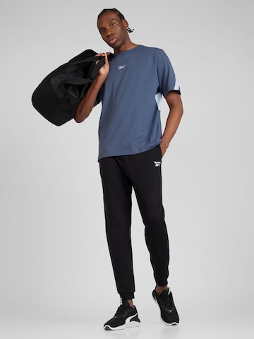 Reebok - Tapered Pantalón deportivo en negro