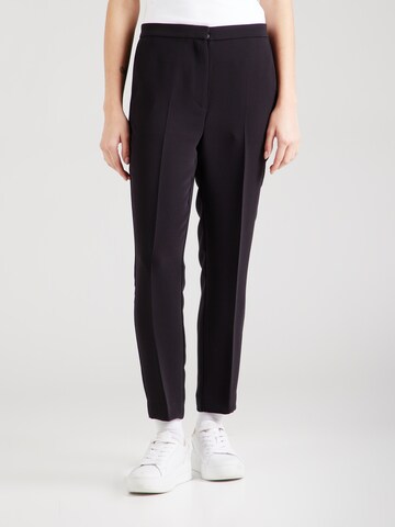 Slimfit Pantaloni con piega frontale di TOMMY HILFIGER in nero: frontale