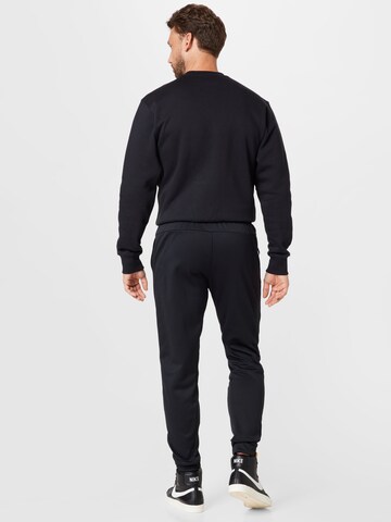 Effilé Pantalon de sport NIKE en noir