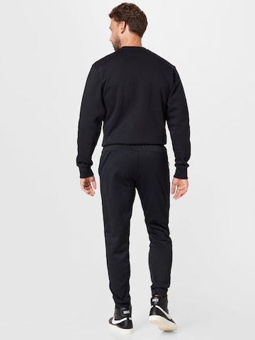 NIKE Tapered Sports trousers in Black