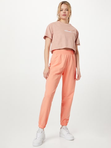 Champion Authentic Athletic Apparel Tapered Broek in Oranje