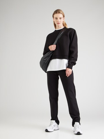 Champion Authentic Athletic Apparel - regular Pantalón en negro