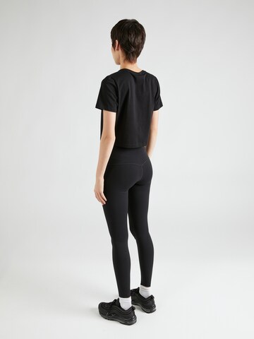 NIKE Skinny Spodnie sportowe 'UNIVERSA' w kolorze czarny