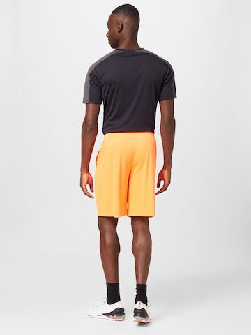 UNDER ARMOUR Ohlapna forma Športne hlače | oranžna barva