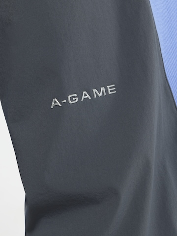 A-Game Štandardný strih Športové nohavice 'Lifewear' - Modrá