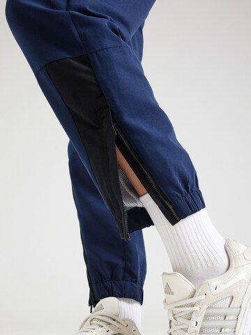 Hummel - Tapered Pantalón deportivo en azul