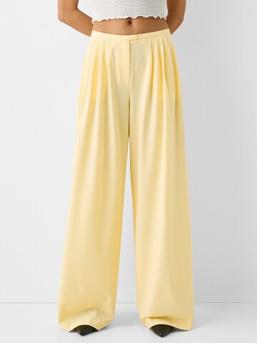 Bershka Wide leg Pleat-Front Pants in Yellow: front