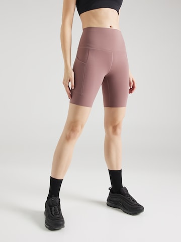 Skinny Pantalon de sport NIKE en violet : devant