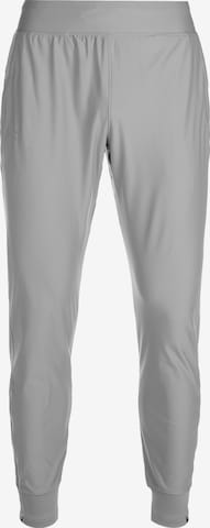 Effilé Pantalon de sport UNDER ARMOUR en gris : devant