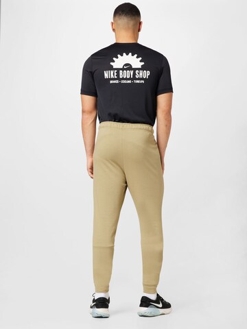 Effilé Pantalon de sport NIKE en beige