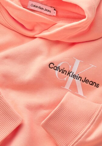 Calvin Klein Jeans كنزة رياضية بلون برتقالي