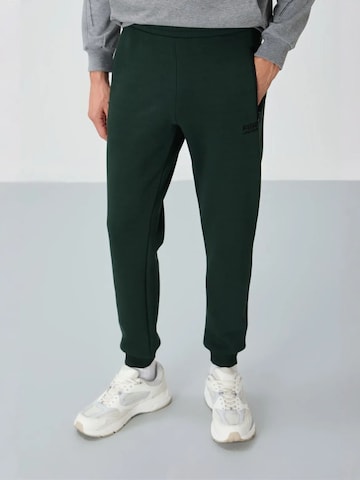 Pantaloni sportivi di Tommy Life in verde: frontale