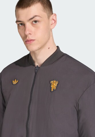 Veste fonctionnelle 'Manchester United Terrace Icons' ADIDAS ORIGINALS en noir