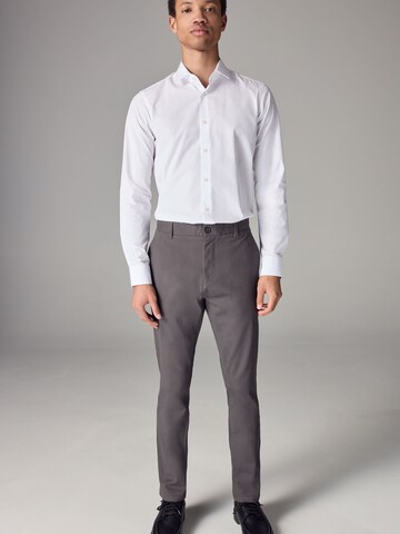 Skinny Pantaloni chino di Next in grigio