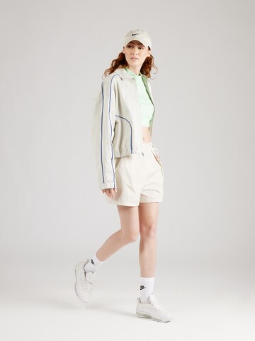 regular Pantaloni con pieghe di Nike Sportswear in beige