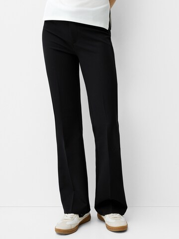 Bershka Flared Trousers with creases in Black: front