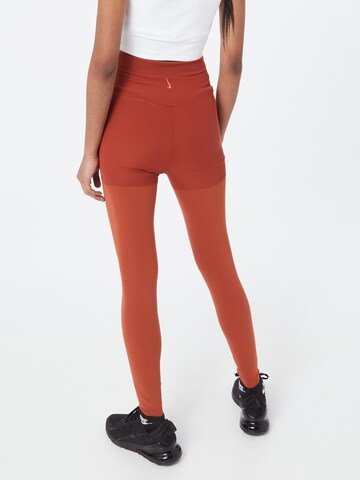 NIKE Skinny Workout Pants in Orange