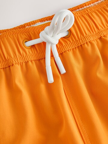 Next - Bermudas 'Motion-Flex' en naranja