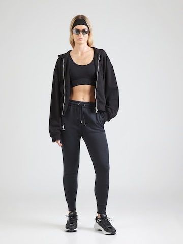 UNDER ARMOUR Tapered Παντελόνι φόρμας σε μαύρο