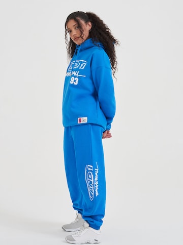 Effilé Pantalon fonctionnel AND1 en bleu