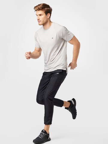 Tapered Pantaloni sport de la ASICS pe negru