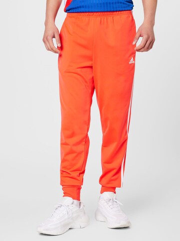 ADIDAS SPORTSWEAR Tapered Workout Pants 'Essentials Warm-Up Tapered 3-Stripes' in Red: front
