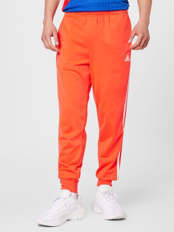 ADIDAS SPORTSWEAR - Tapered Calças de desporto 'Essentials Warm-Up Tapered 3-Stripes' em vermelho: frente