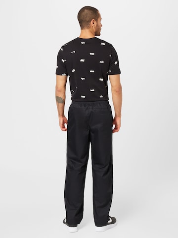 Loosefit Pantalon 'Club' Nike Sportswear en noir