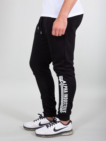 Effilé Pantalon ALPHA INDUSTRIES en noir