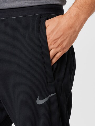 NIKE Regular Sports trousers in Black