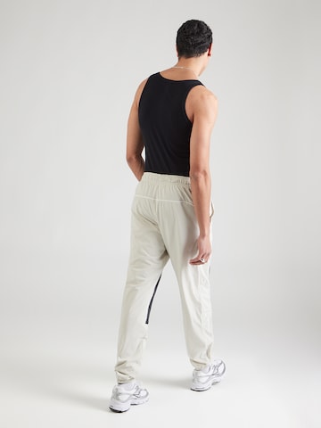 pelēks Nike Sportswear Pakapēniski sašaurināts piegriezums Bikses 'AIR'