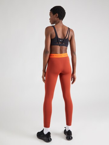 NIKE Skinny Urheiluhousut värissä oranssi