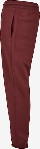 Tapered Pantaloni di Urban Classics in rosso