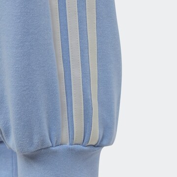 Tapered Pantaloni 'Graphic Print' de la ADIDAS ORIGINALS pe albastru